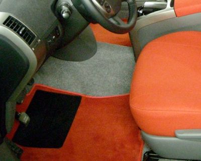 Primo piano della moquette rossa su misura e della fodera in tessuto di una Toyota Prius